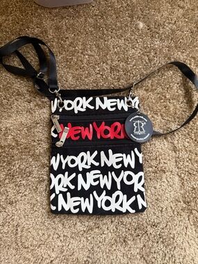 Robin Ruth Black Crossbody Bag with White Script and Red Accent